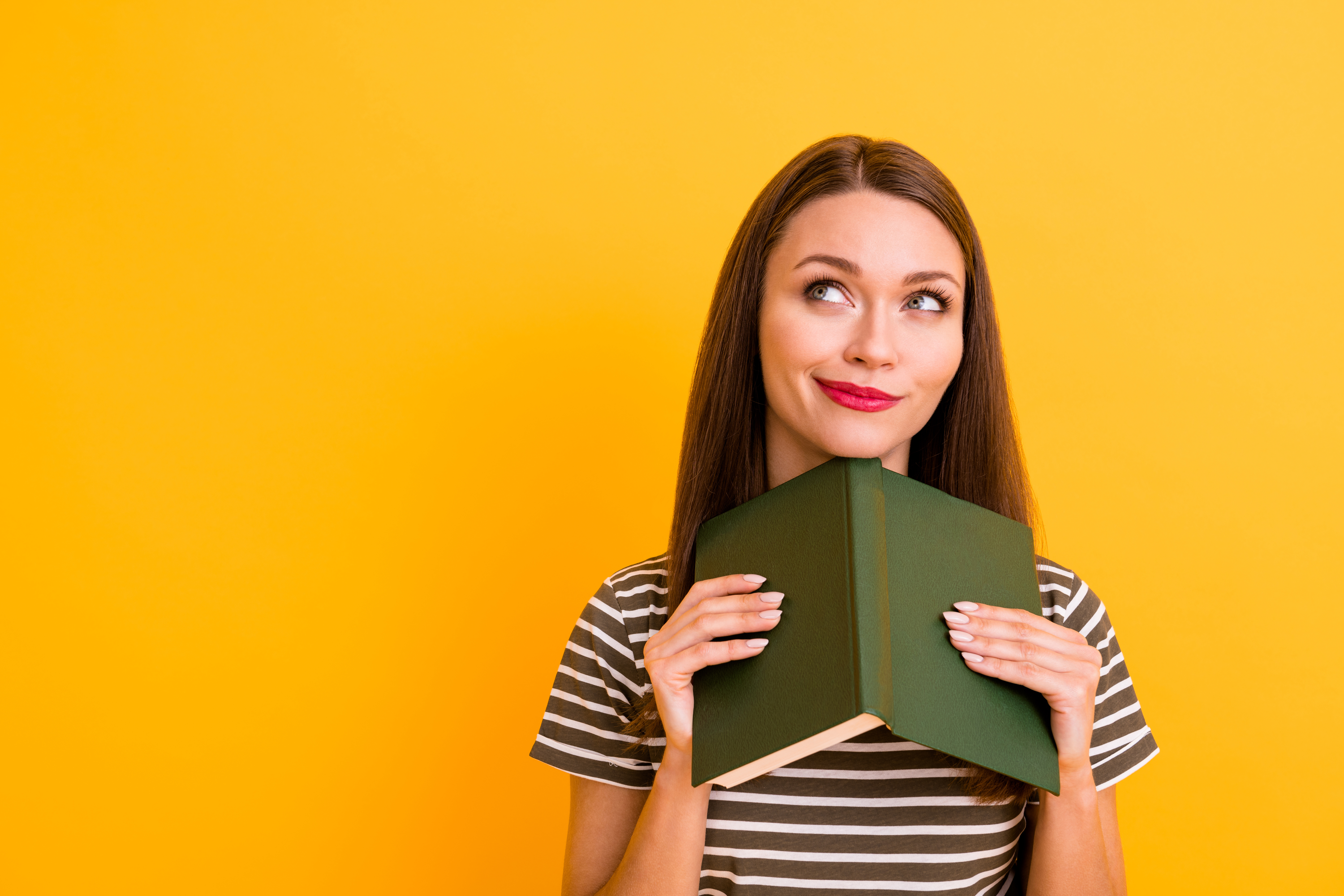 Close up photo of dreamy positive girl red lips-stick rest relax read poetry book, think thoughts imagine story look copy space wear stylish clothing isolated yellow color background